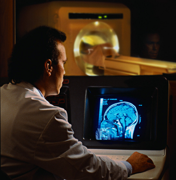 Doctor Examining Brain CAT Scan, Warren Morgan/CORBIS