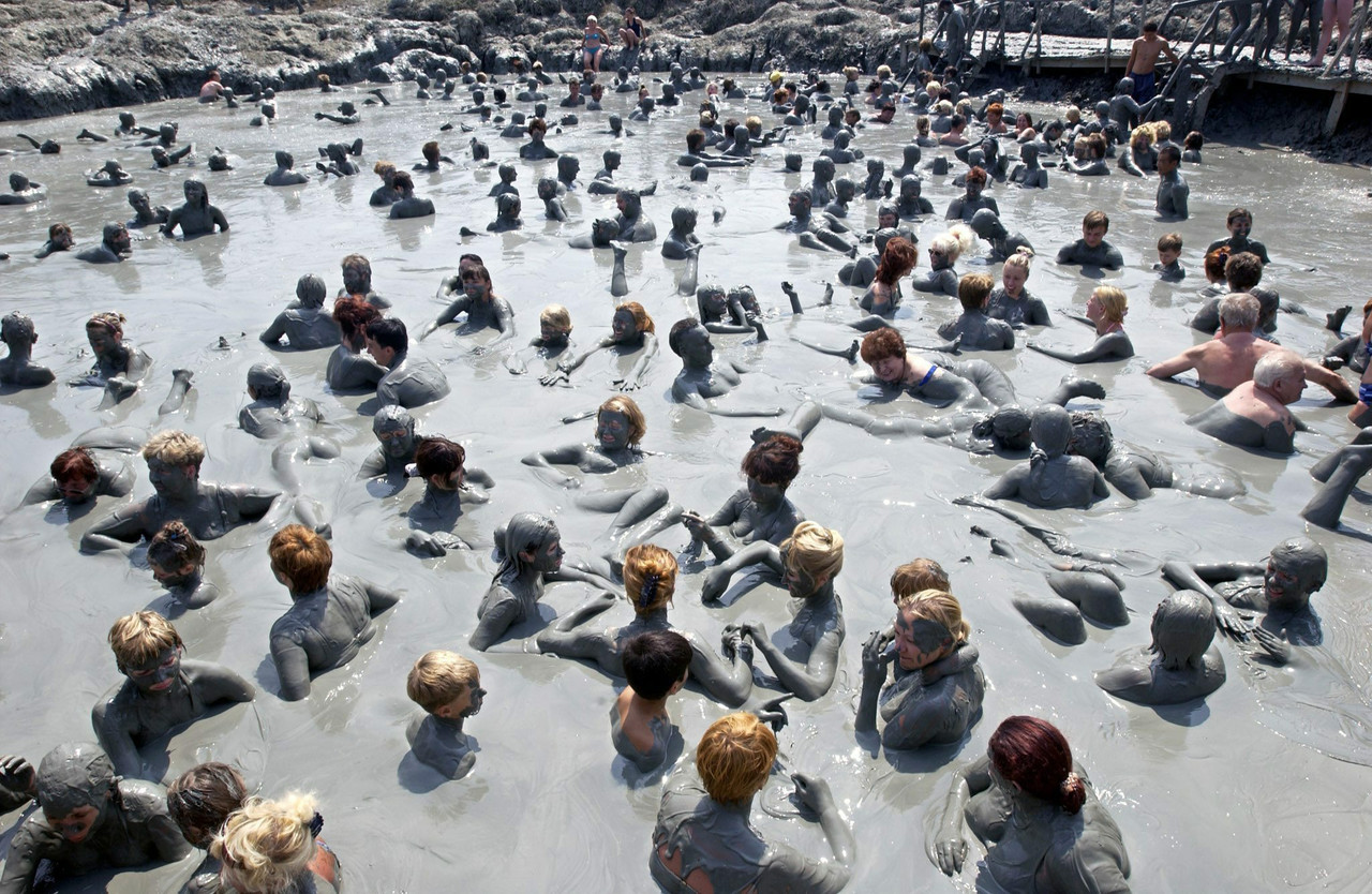 People enjoy a bath in the mud, STR/epa/Corbis