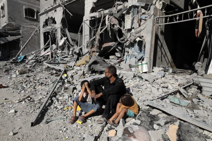 Un uomo e due bambini dopo un bombardamento a Gaza